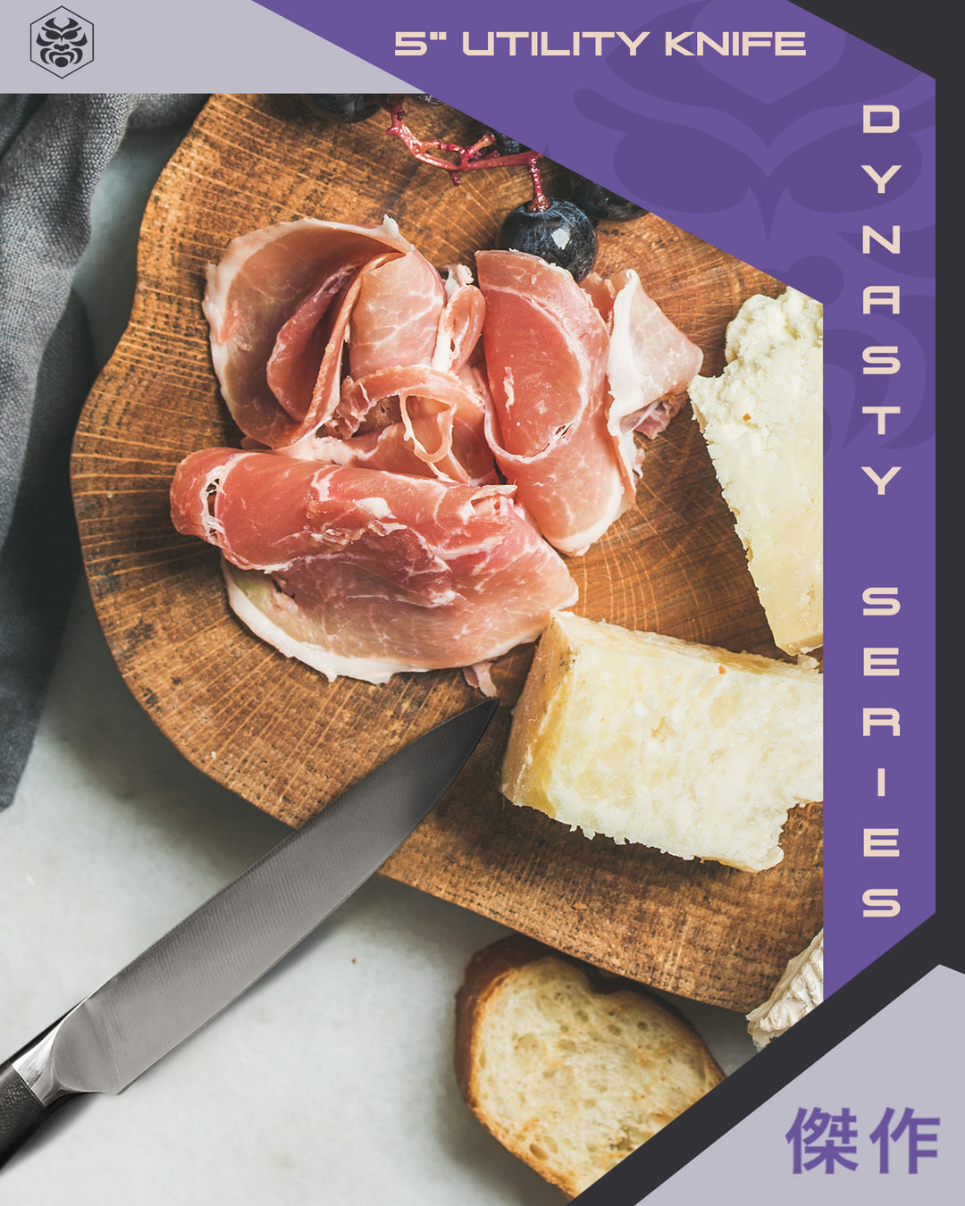 The Dynasty Utility Knife with sliced wedges of cheese, cured meat, and bread, as well as grapes