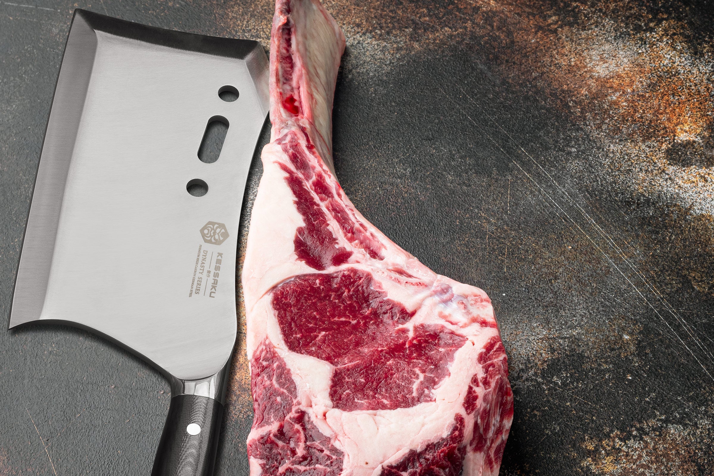 The Dynasty Annihilator Cleaver Knife next to a trimmed tomahawk steak. 