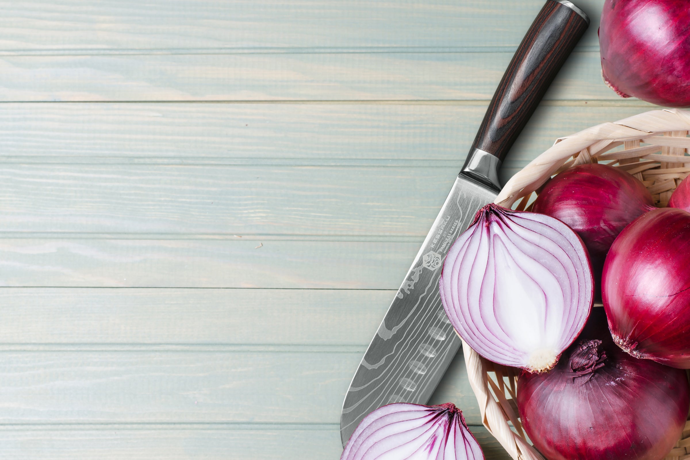 The Samurai Santoku next to red onions.