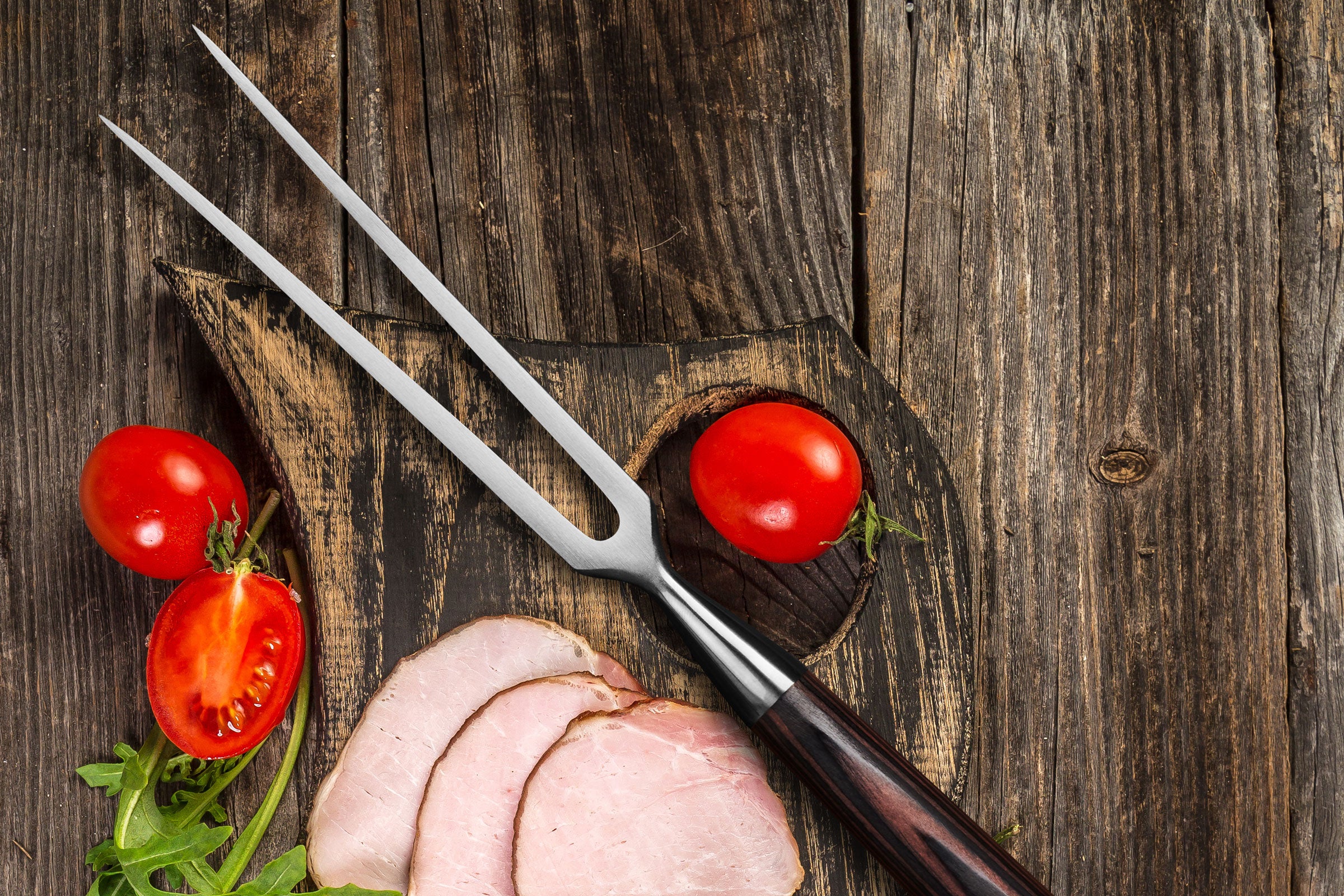 The Samurai Carving Meat Fork with slices of turkey, and cherry tomatoes.
