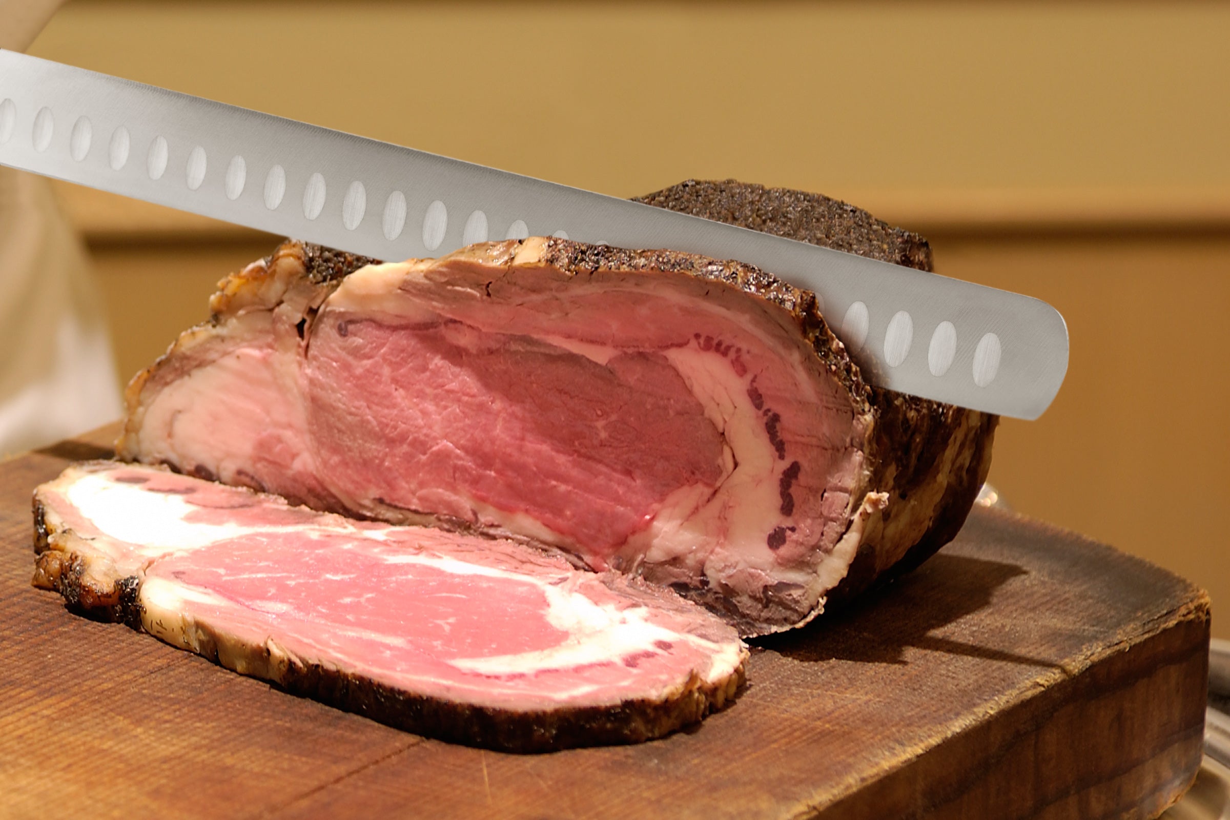 A chef slicing through roast beef with with Spectre Carving Knife