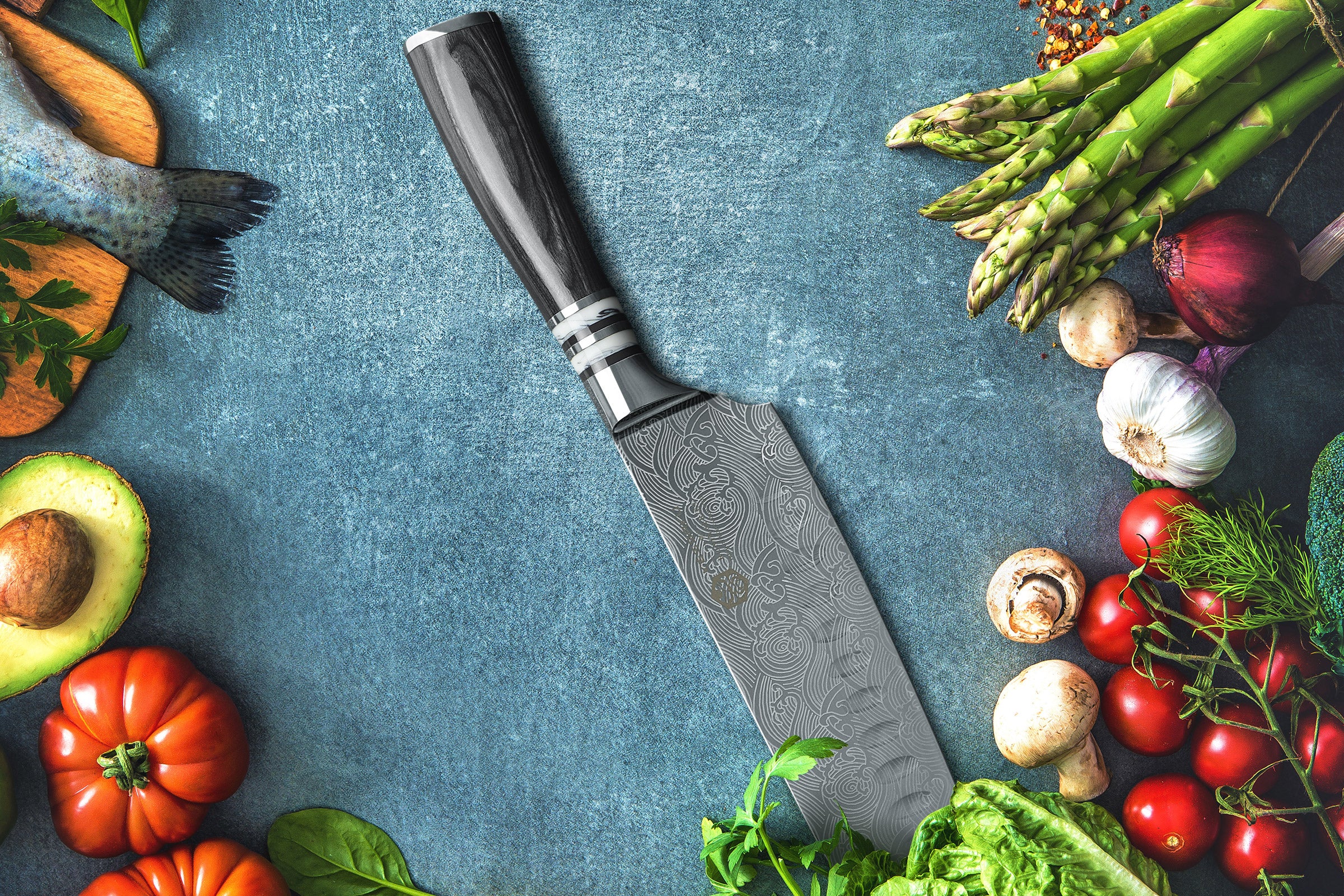 The Ronin Santoku surrounded by heirloom tomatoes, avocado, fish, asparagus, garlic, mushrooms, cherry tomatoes, and lettuce.