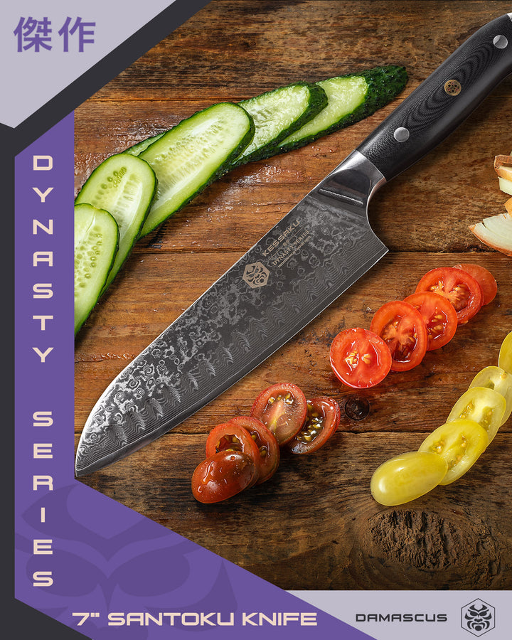 The Damascus Santoku surrounded by sliced cucumber, tomato, and onion