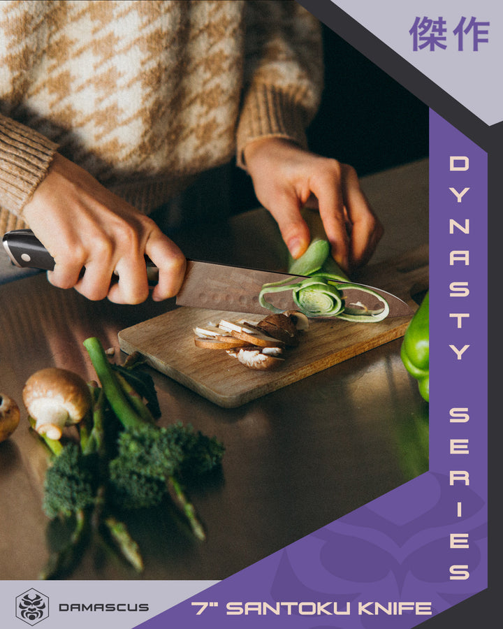 A woman slicing vegetable with the Damascus Santoku knife