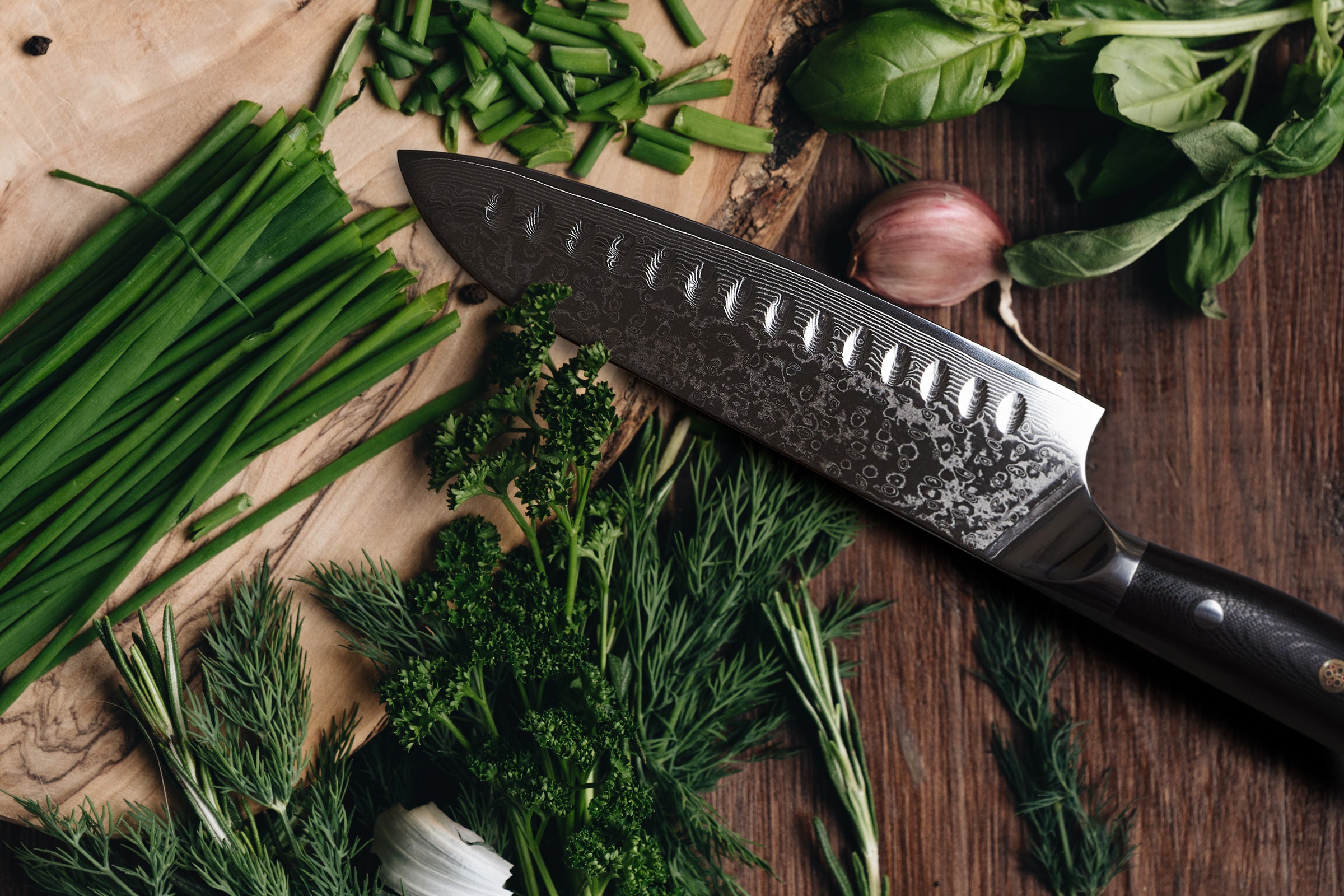 The Dynasty Damascus Santoku chopping green onions.