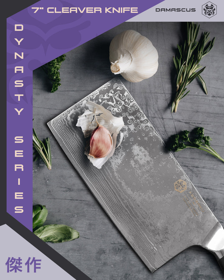 The Dynasty Damascus Cleaver with garlic cloves and various herbs.