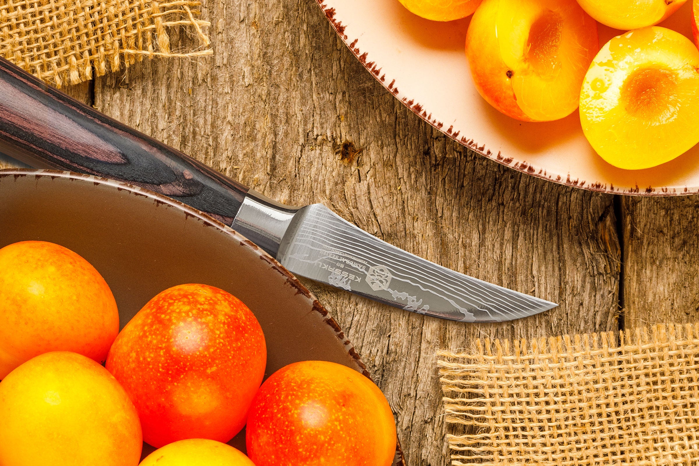 The Samurai Bird's Break knife with halved, pitted peaches.