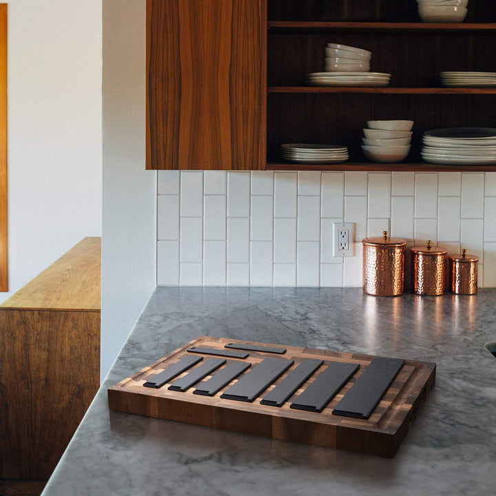 The Universal 9 Piece Knife Sheath Set laid out in a kitchen