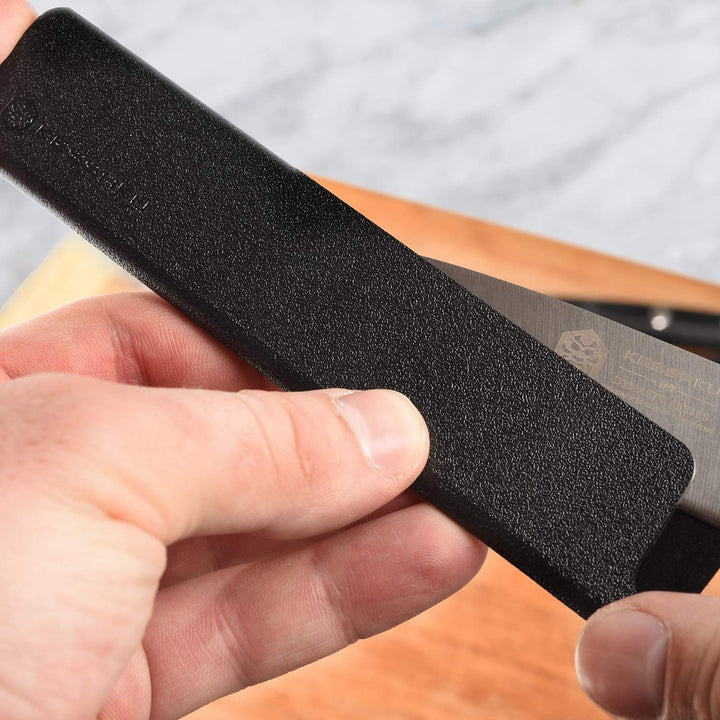A man inserts a utility knife into a small knife sheath