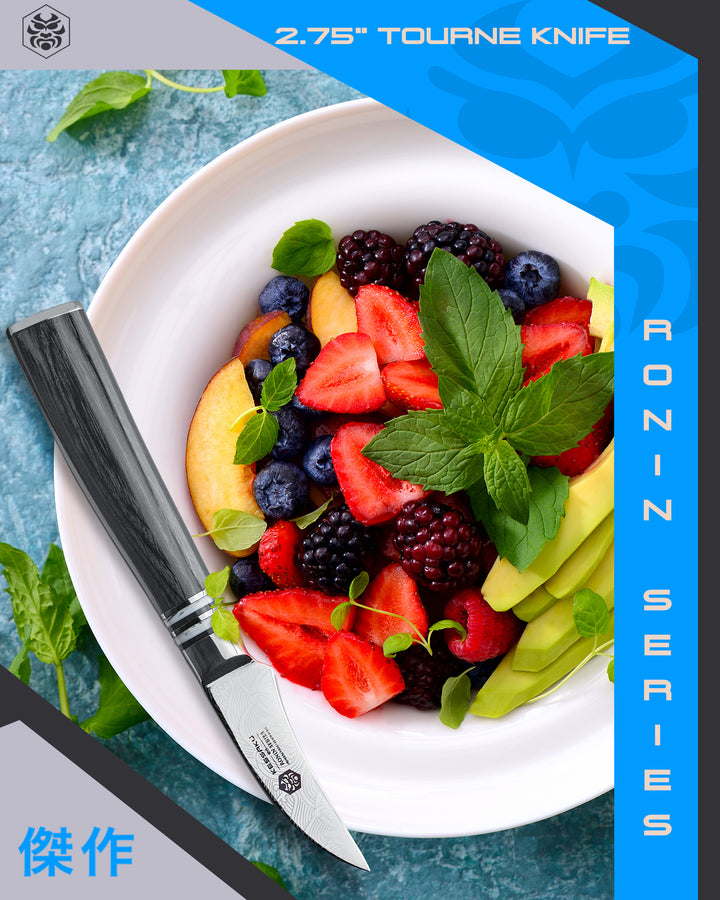 The Ronin Tourne Knife lays atop a bowl after slicing strawberries, peach, and avocado