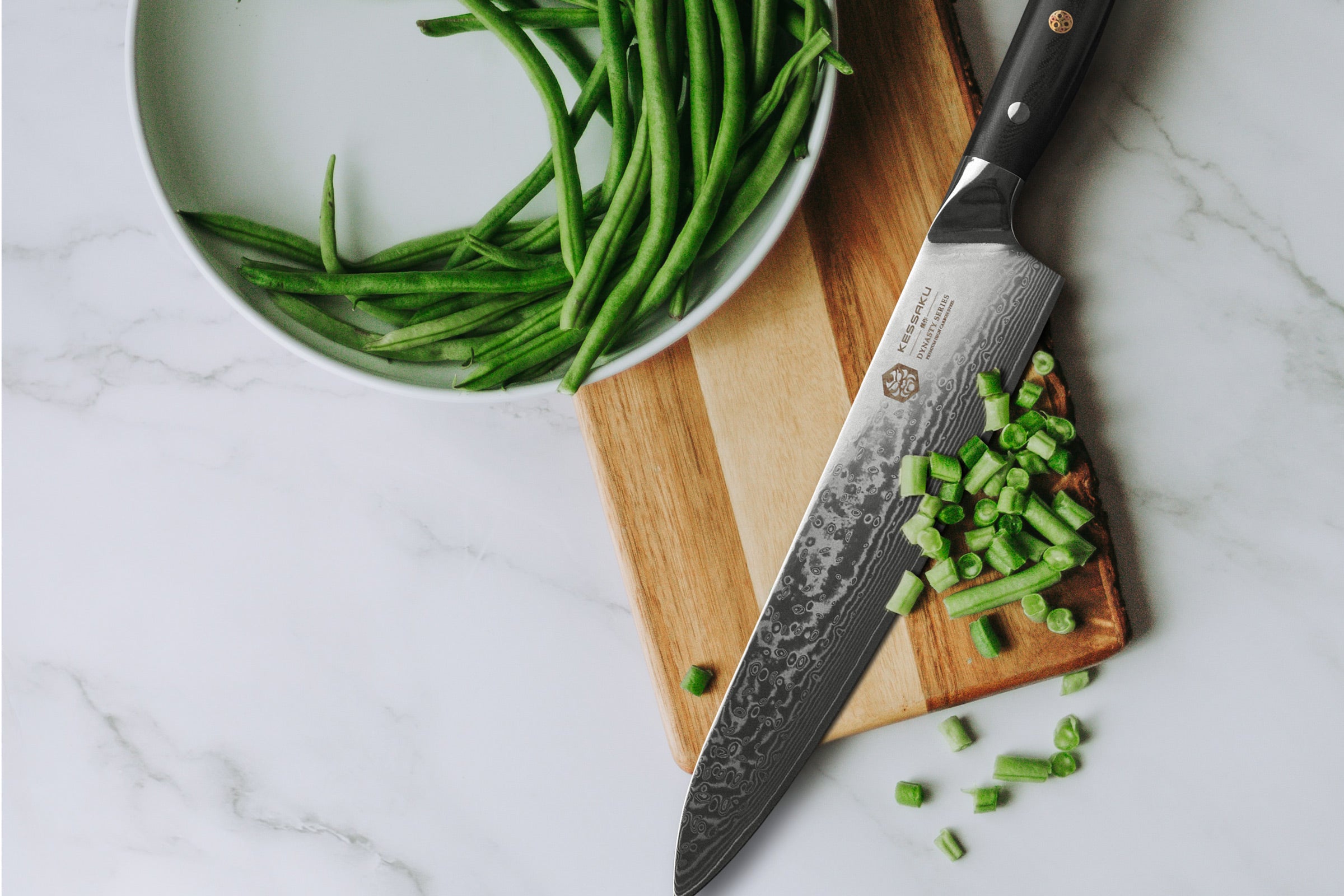 The Dynasty Damascus large Chef's Knife used to slice up green beans
