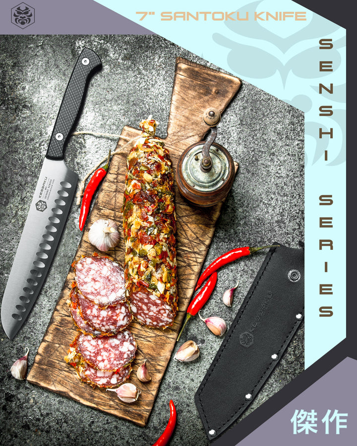 The Senshi Santoku Knife and its Leather Sheath next to a cutting board with cured meat, red peppers, and garlic
