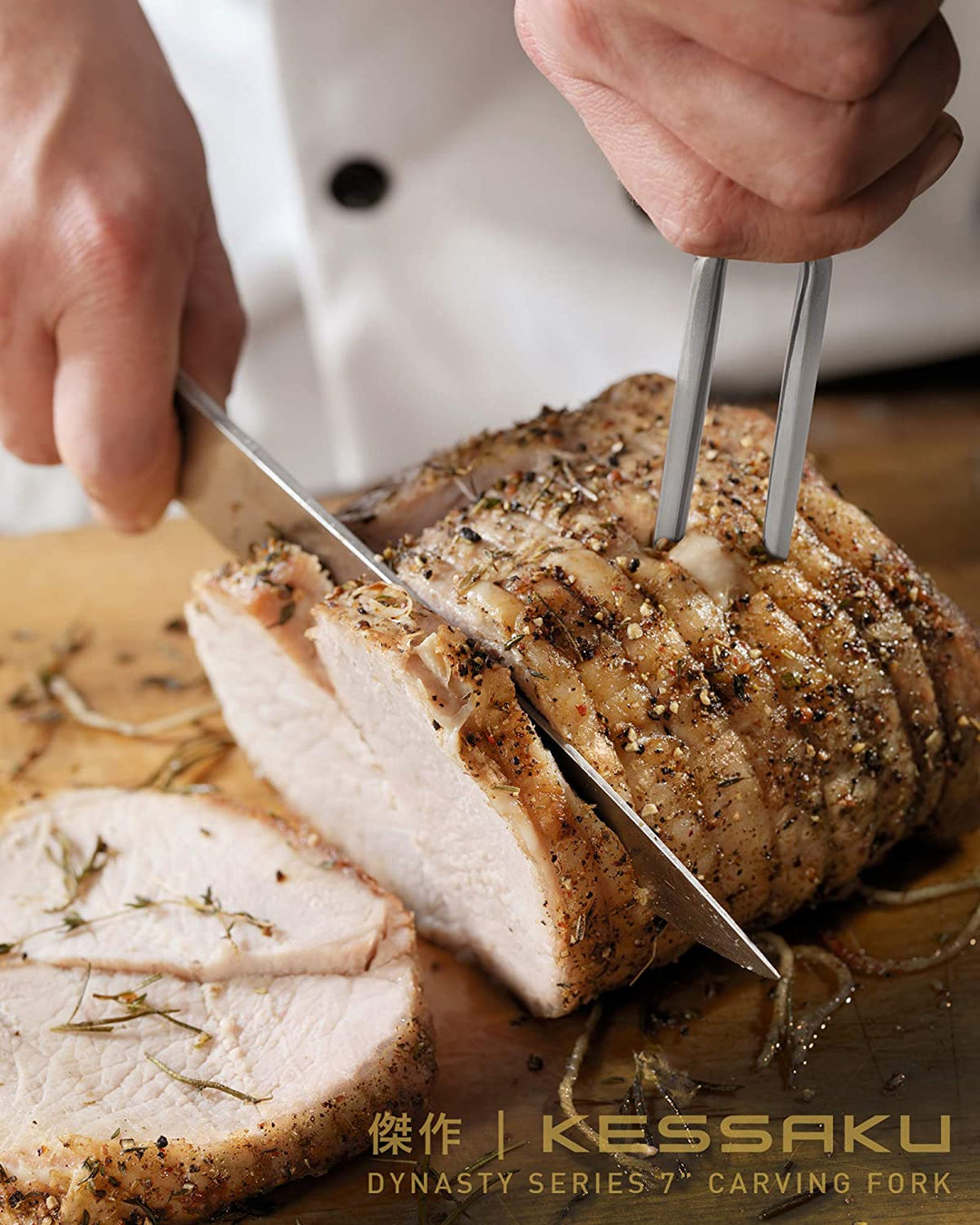 A chef carves thick cuts of chicken with the Dynasty Carving Fork