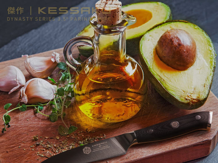 The Dynasty Paring Knife with halved avocado, garlic, and olive oil on a cutting board