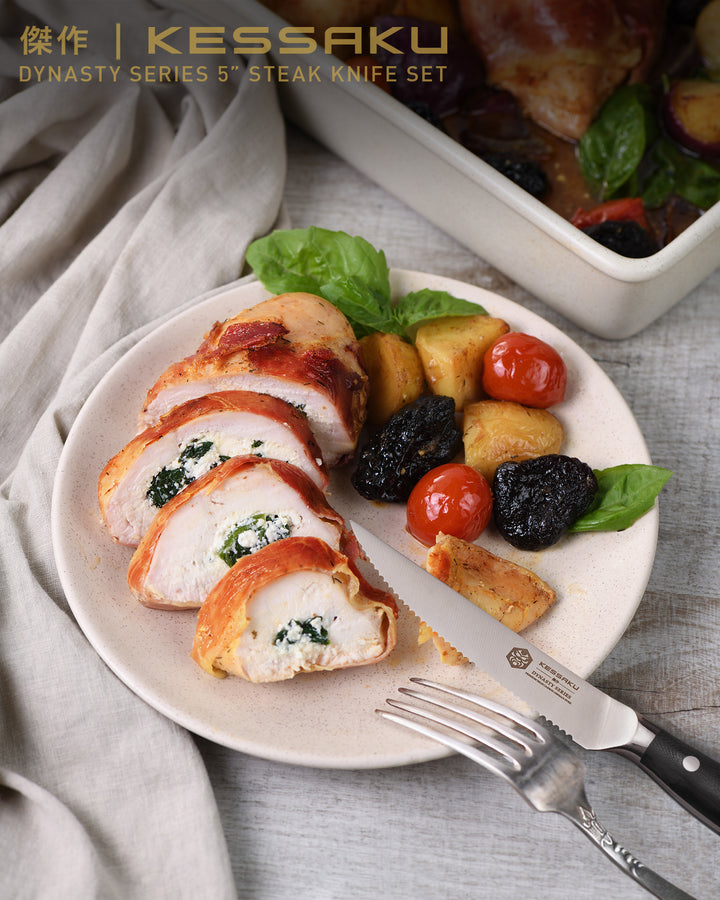 A plate of chicken Kiev with roasted potatoes, cherry tomatoes, and basil 